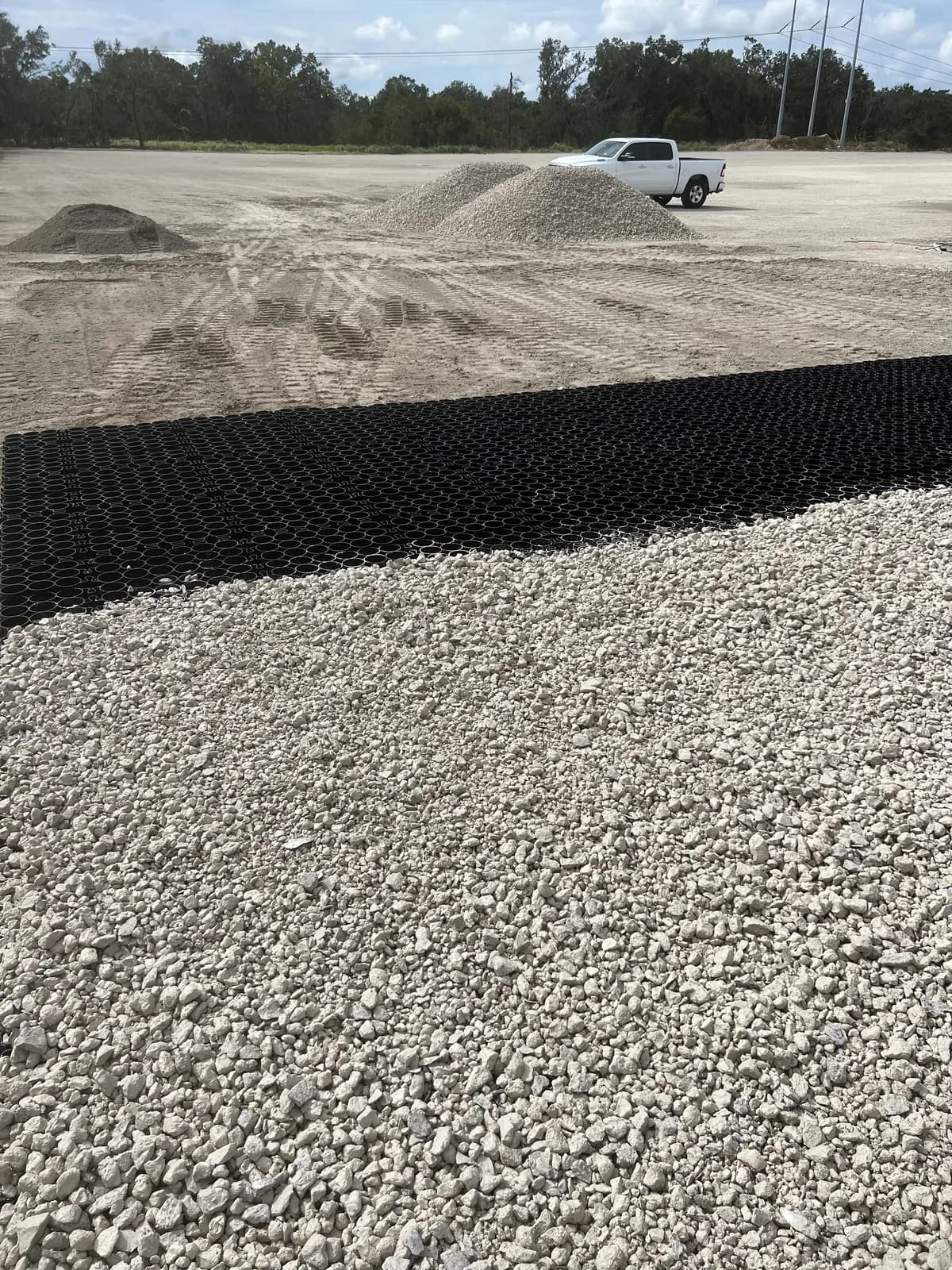Permeable paver grid filled with crushed base in a lot